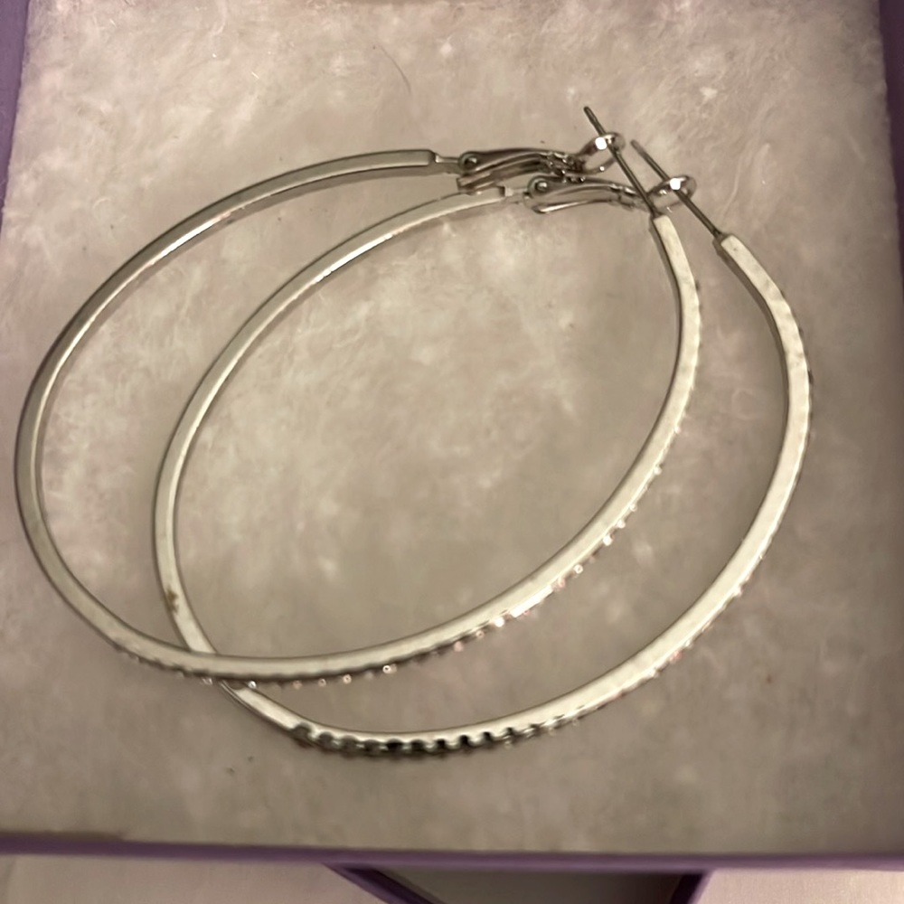 Silver hoop earrings never worn.  Lined with crystals.